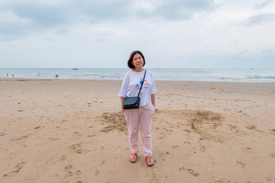 Full length of woman standing on beach