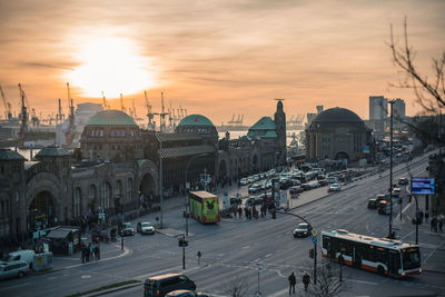 Group of people on city street at sunset