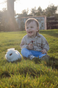 Portrait of cute boy standing in field