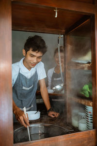 Side view of man preparing food at home