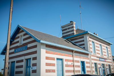 Low angle view of buildings against blue sky