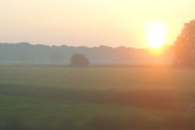 Scenic view of landscape against sky at sunset
