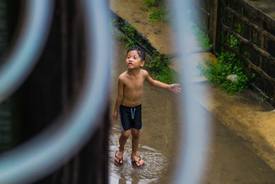 Full length portrait of boy standing at camera