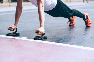 Low section of man skateboarding on floor