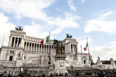 Low angle view of flags against famous italian monument