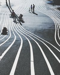 Low section of people riding motorcycle on road