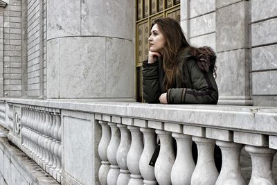 Beautiful young woman sitting outdoors