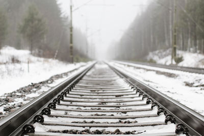 Snow covered railroad track at countryside