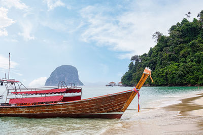 Thai traditional wooden longtail boat at beautiful beach and bay.