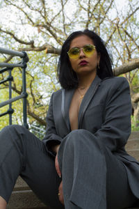 Portrait of young woman sitting in park