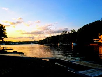 Scenic view of river against sky at sunset