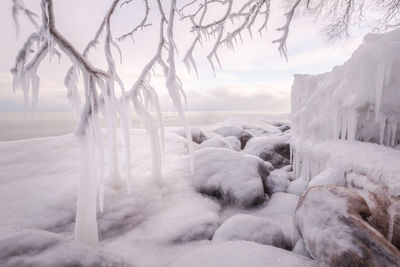 Scenic view of snow covered sea against sky