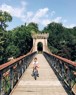 Boy walking on footbridge