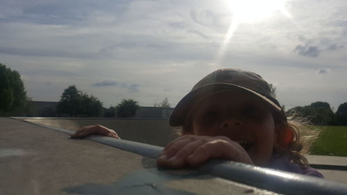 Portrait of boy in car against sky