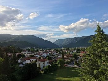 Townscape by mountains against sky