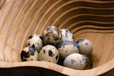 High angle view of quail eggs in wooden container