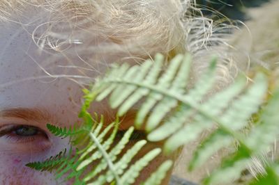 Cropped portrait of girl with leaves