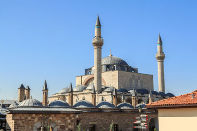 Low angle view of mosque against blue sky