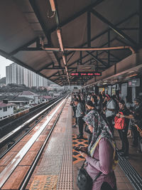 People waiting at railroad station platform