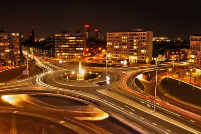 High angle view of light trails on highway at night