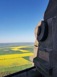 Scenic view of agricultural field against clear blue sky