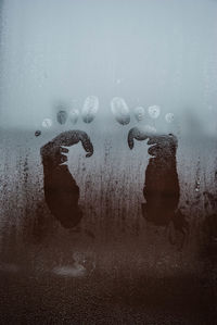 Close-up of human hand with reflection in water