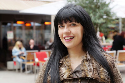 Portrait of happy beautiful woman in city