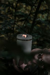 Person holding burning candle