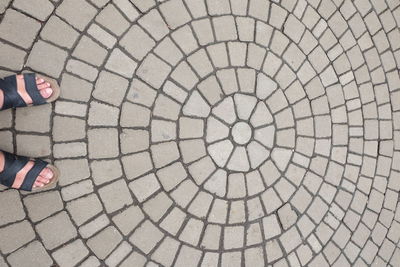 Low section of woman standing on tiled floor