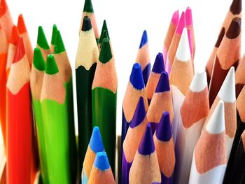 Close-up of colored pencils against white background