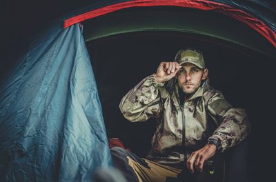 Portrait of man sitting in tent