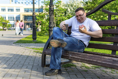 Portrait of man sitting on bench