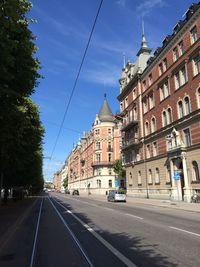 Empty road along buildings