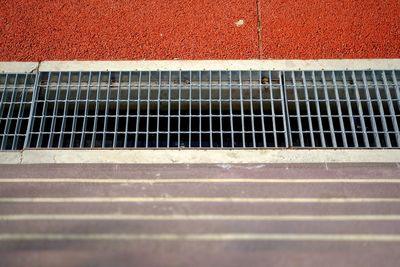 High angle view of metal grate on street