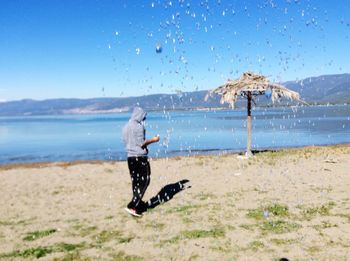 Full length of man on beach against sky