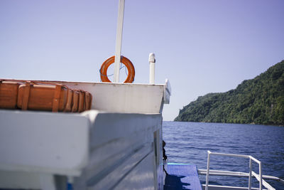 Boat moored on sea against clear sky