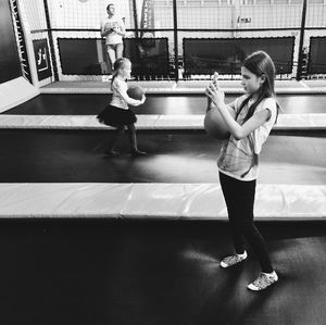 Full length of woman standing by railing