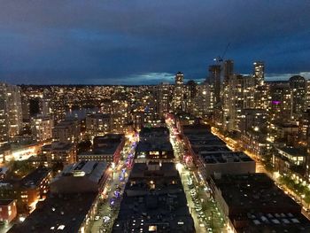 Aerial view of city lit up at night