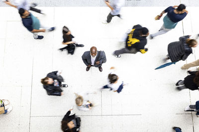 Senior businessman amidst commuters at railroad station