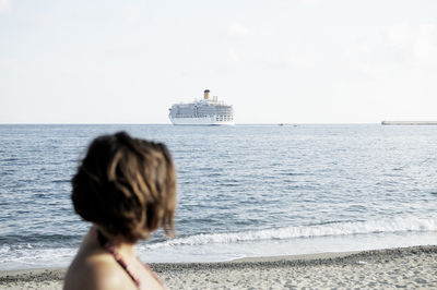 Rear view of woman looking at sea against sky