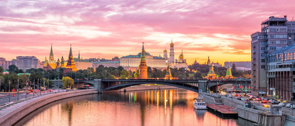 Bridge over river with buildings in background