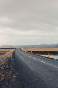 Road amidst landscape against sky