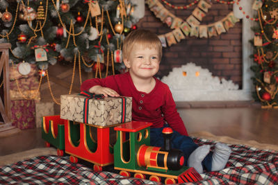 Portrait of happy boy in christmas tree