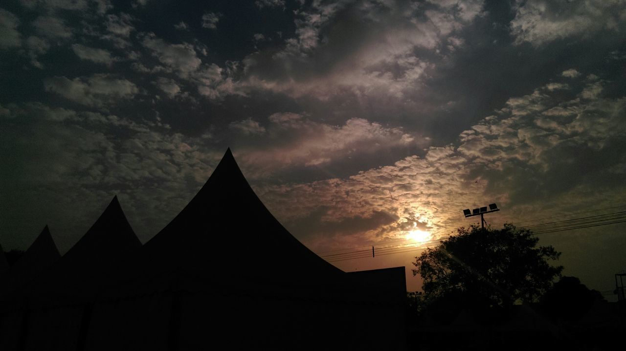 silhouette, sunset, building exterior, sky, architecture, built structure, cloud - sky, low angle view, tree, cloudy, beauty in nature, nature, scenics, dusk, orange color, cloud, outdoors, dramatic sky, house, tranquility