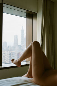 Man and woman relaxing on window in city