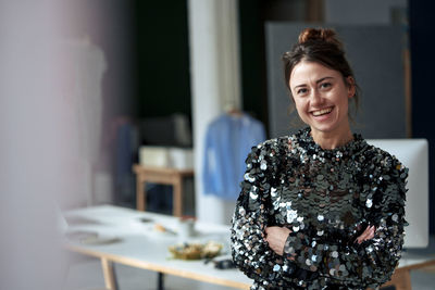 Happy beautiful businesswoman wearing sequin dress at home office