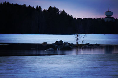 Scenic view of frozen lake against sky during winter