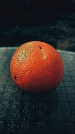 Close-up of orange apple on table