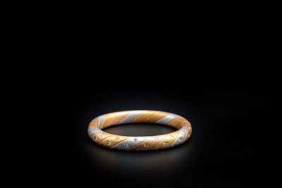 Close-up of ring over black background