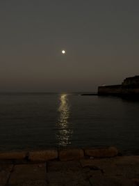 Scenic view of sea against sky at night